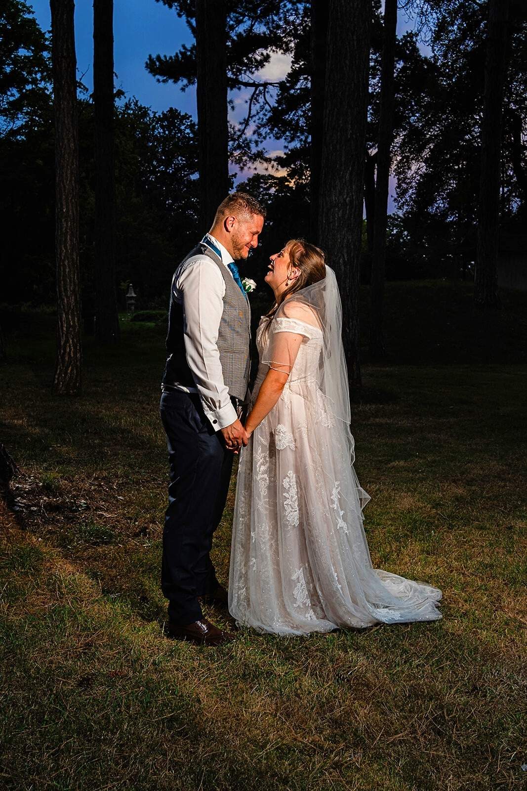 bride and groom in the woods at night time have a photoshoot