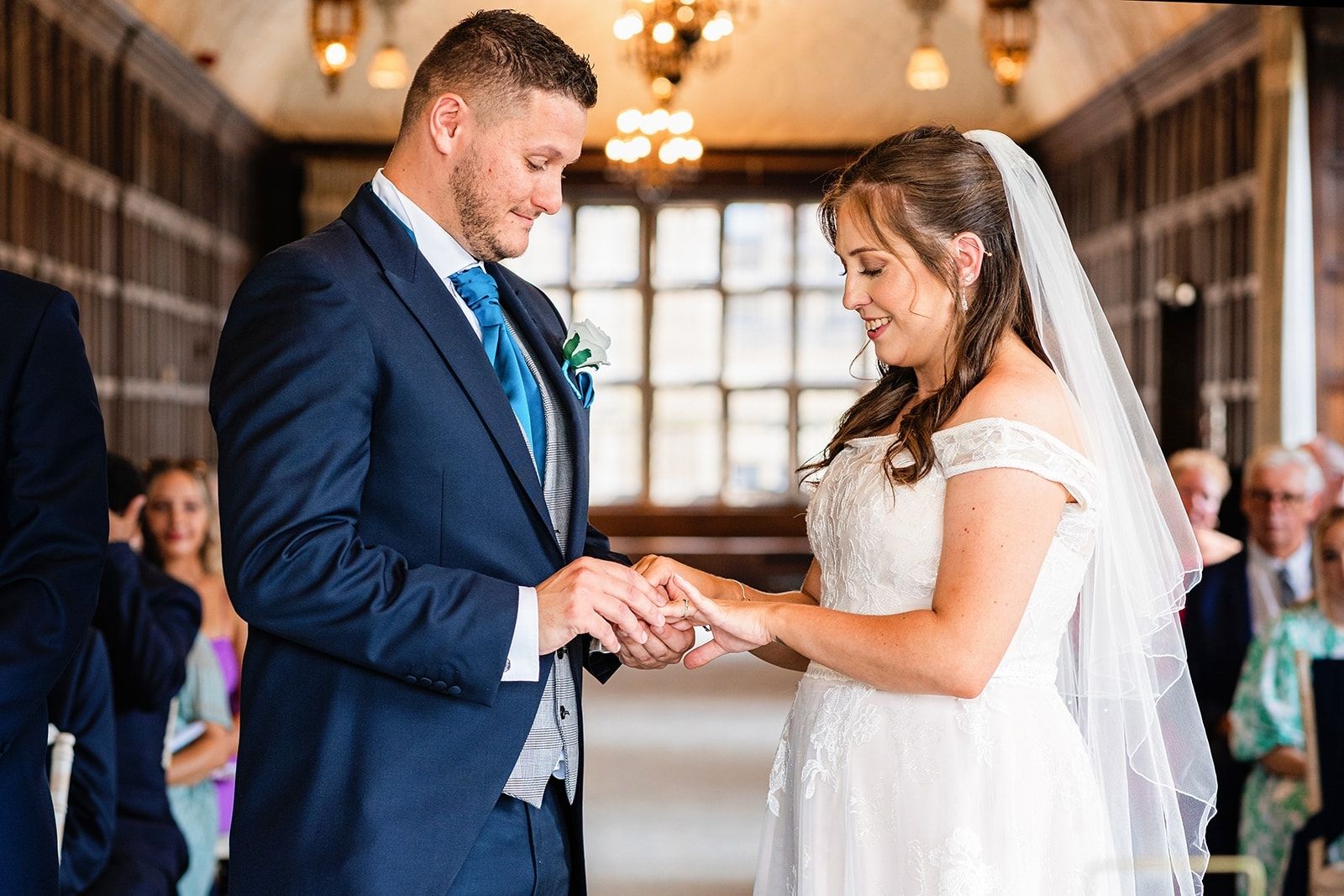 groom puts on his brides wedding ring
