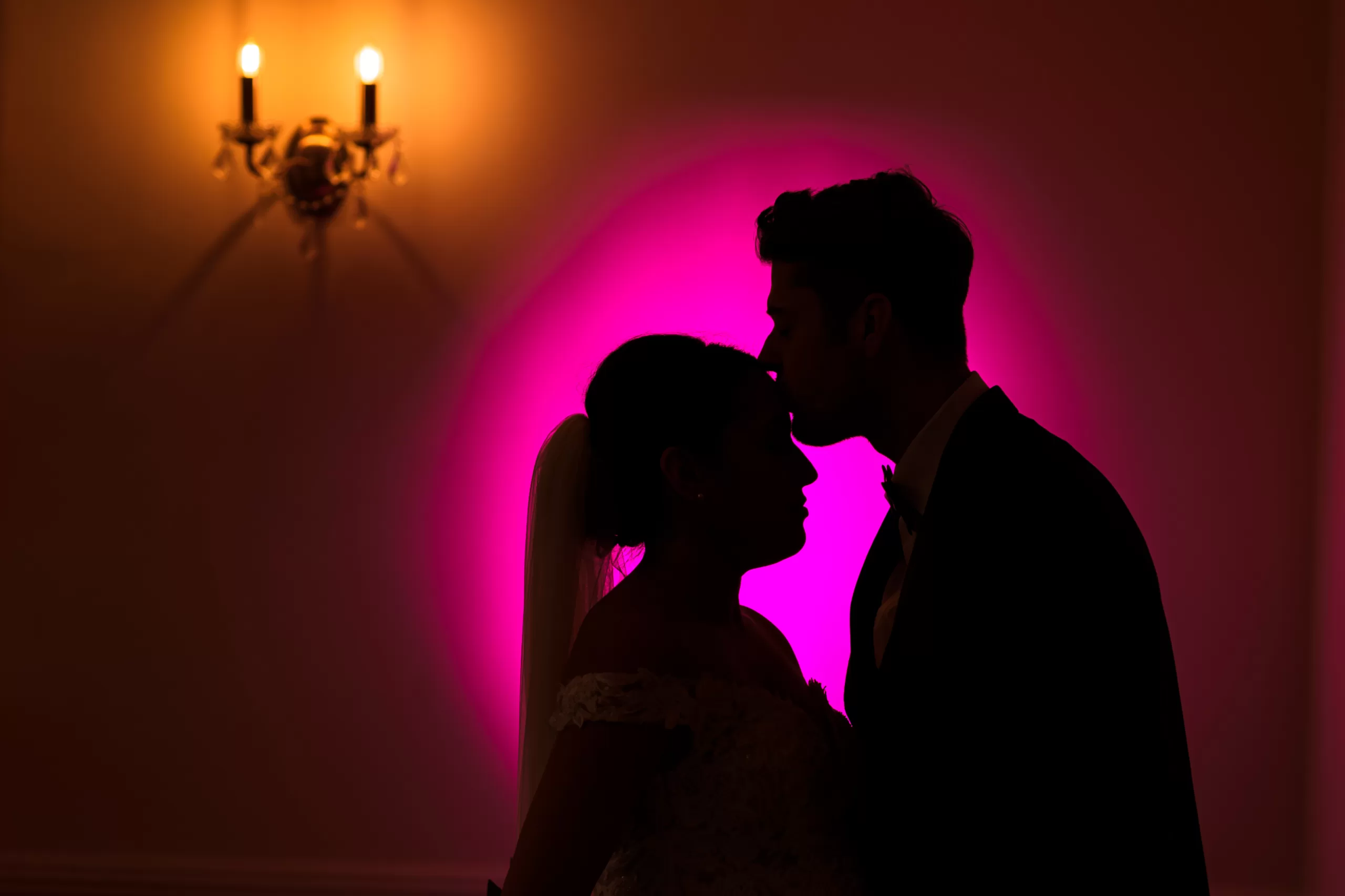wedding photographers essex couple in silhouette with pink background at parklands quendon hall
