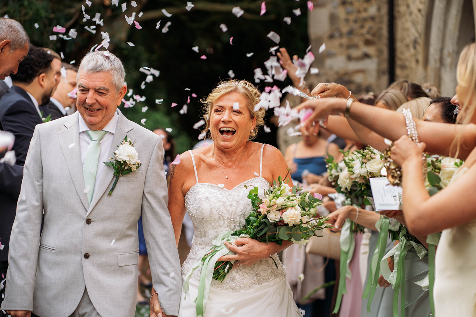 mature couple walk through confetti after saying i do