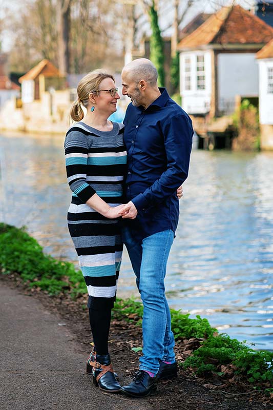 couple standing by river in ware hertfordshire