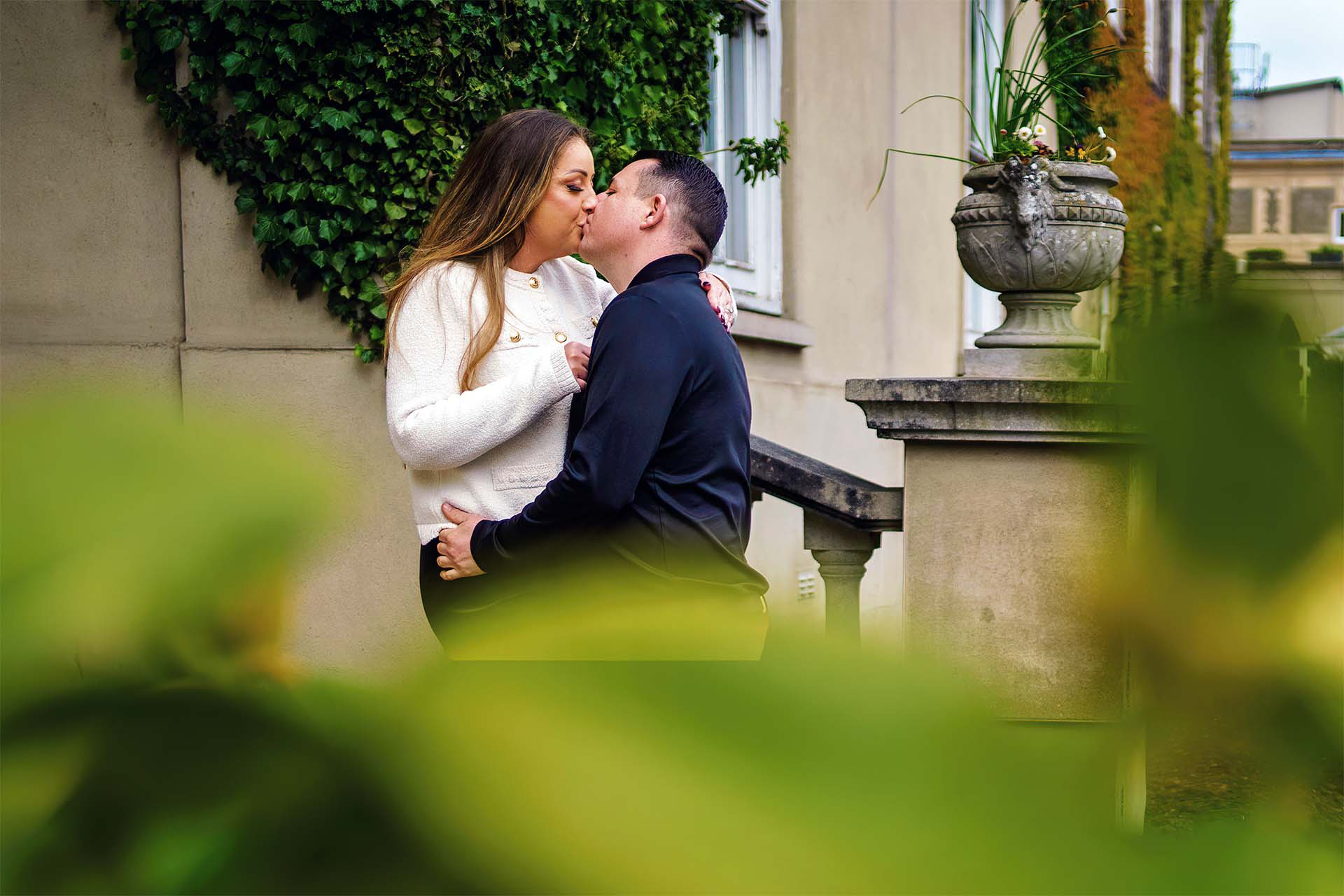 engagement photoshoot at down hall couple on the steps kissing