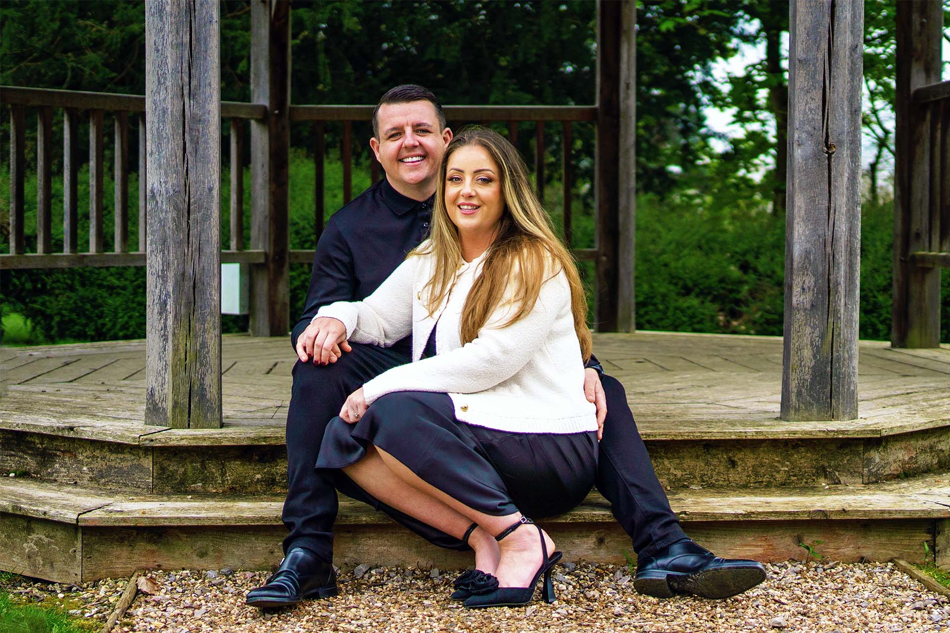 couple sitting on steps having an engagement shoot at down hall hotel