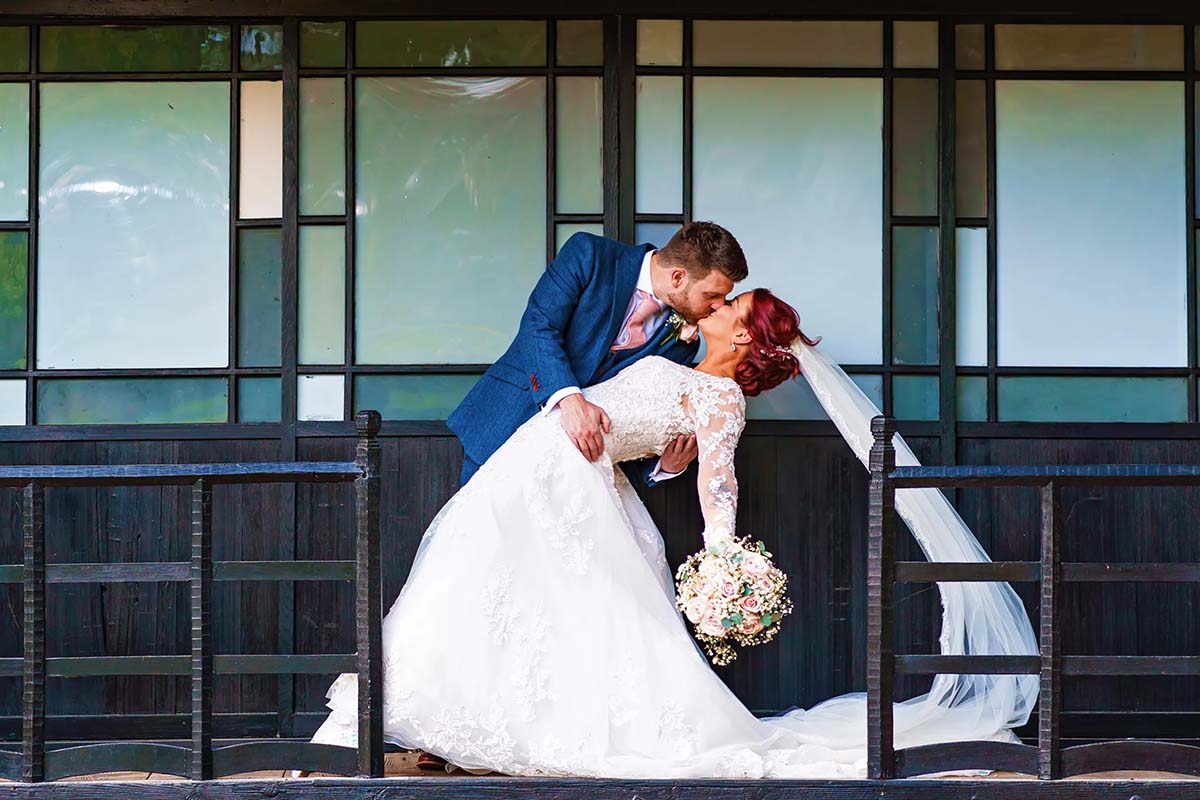bride and groom at the japanese tea house at fanhams hall kissing