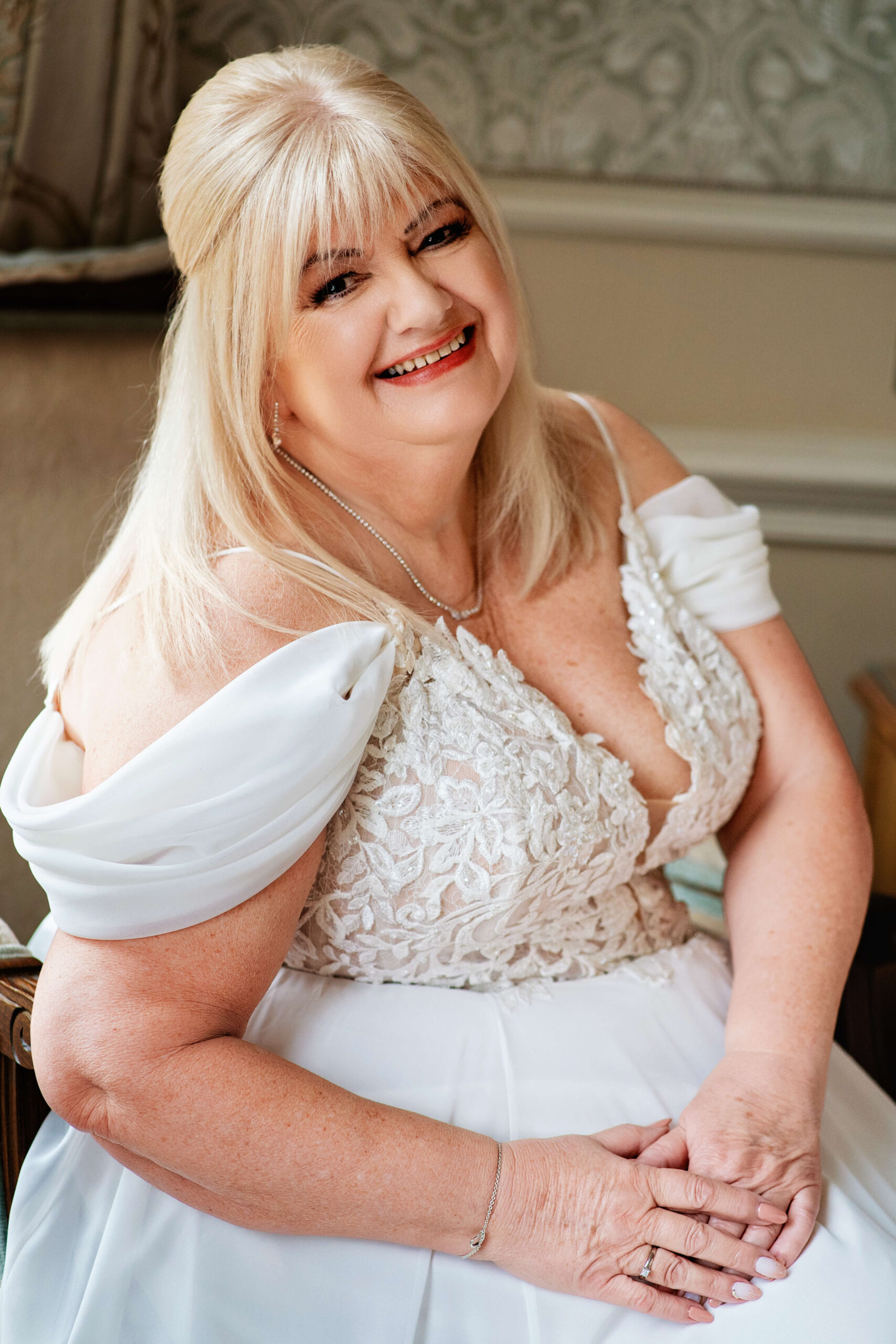 down hall wedding - bride sitting on chair