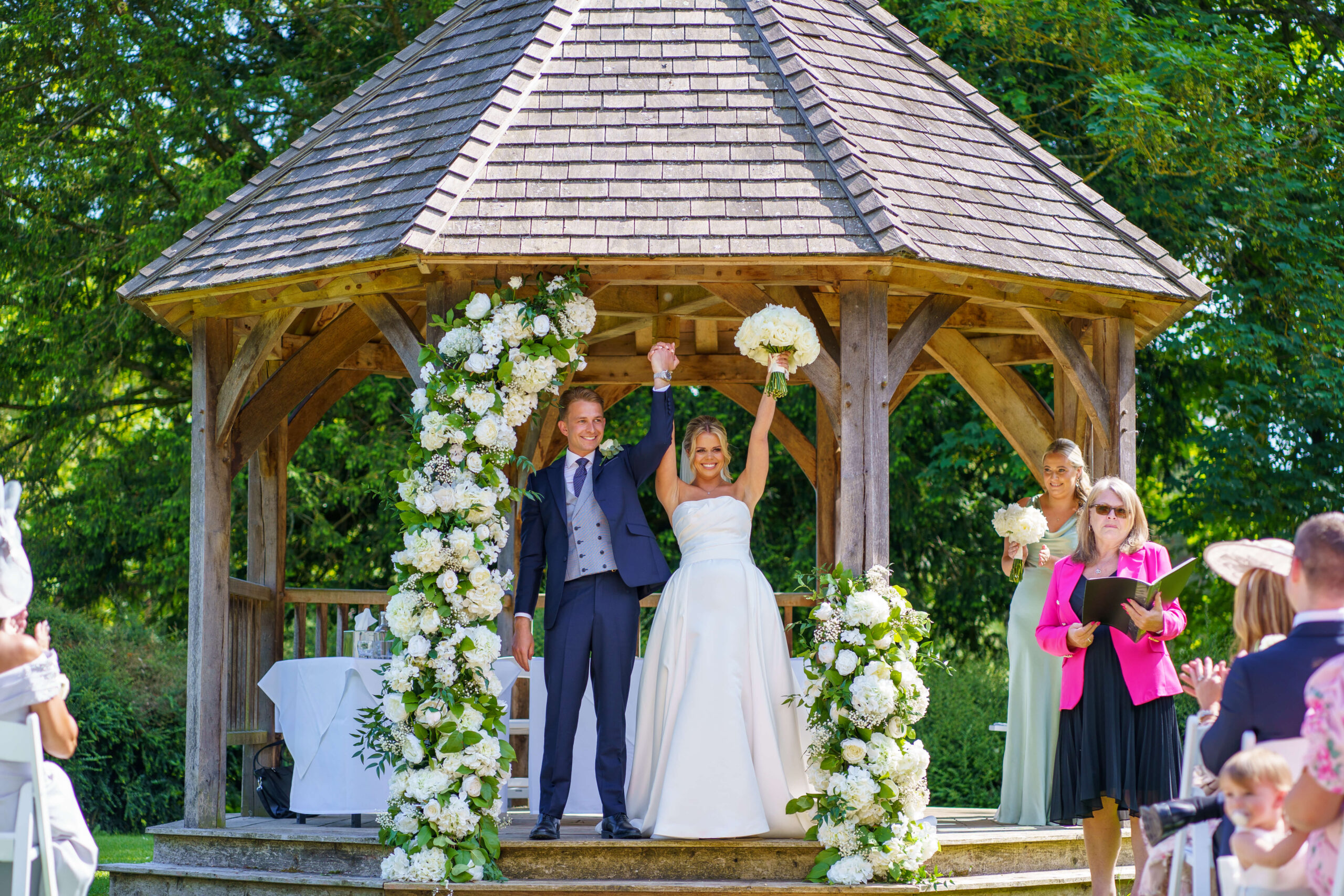 down hall weddings - bride and groom are pronounced bride and groom with arms in the air