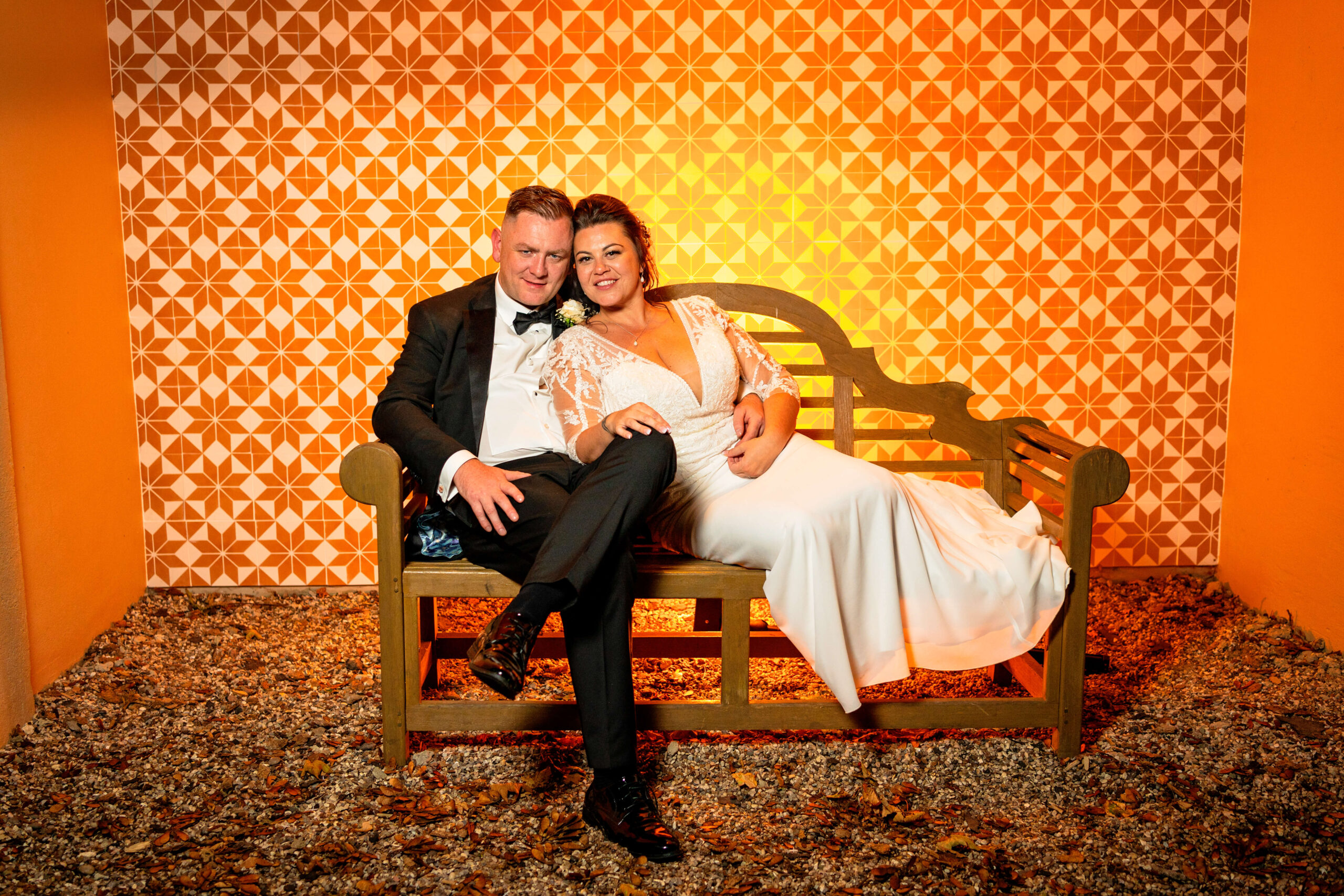 how much does a wedding cost - bride and groom in the evening surrounded by orange light