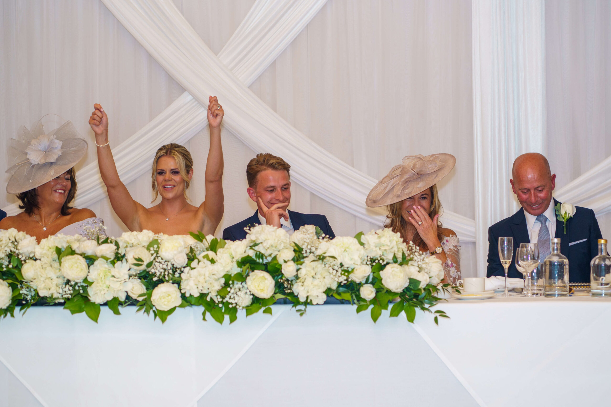 down hall weddings - wedding party sat a top table 