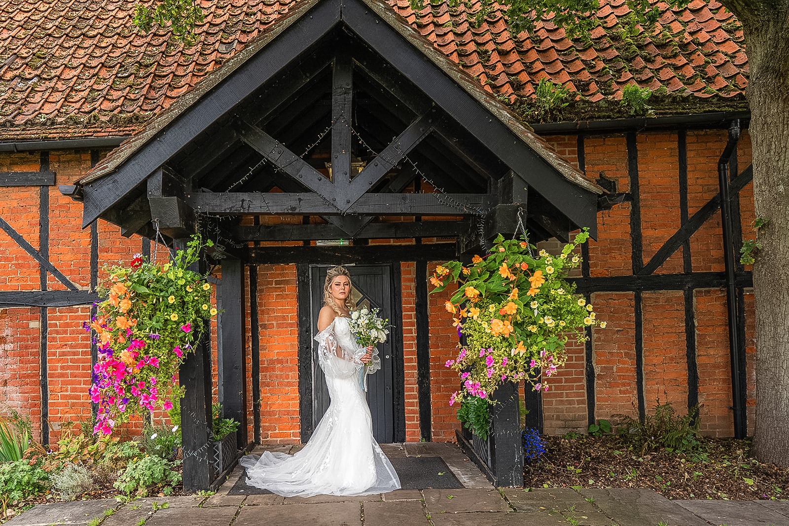 bride standing in the doorway of the tithe barn bedford