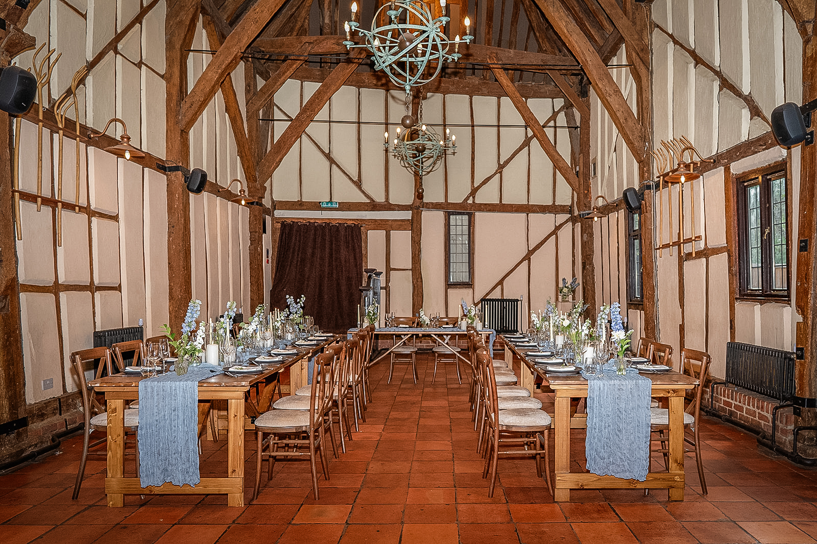 the interior of the tithe barn bedford set up for a wedding