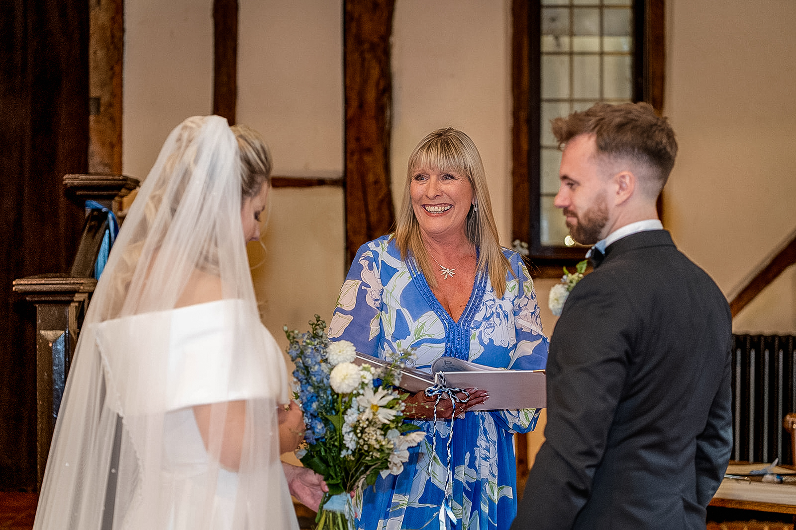 the bride and groom tie the knot with their celebrant