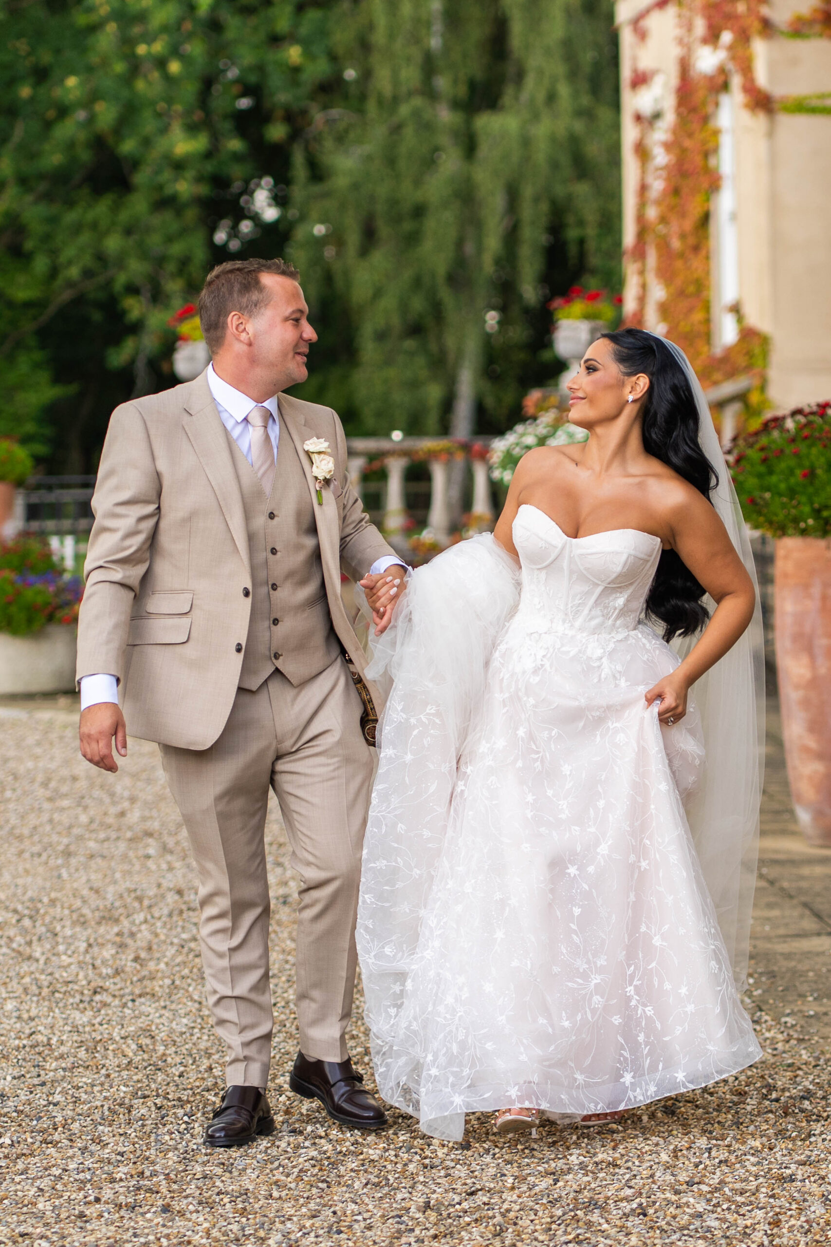 bride and groom in love walking together looking at each other.