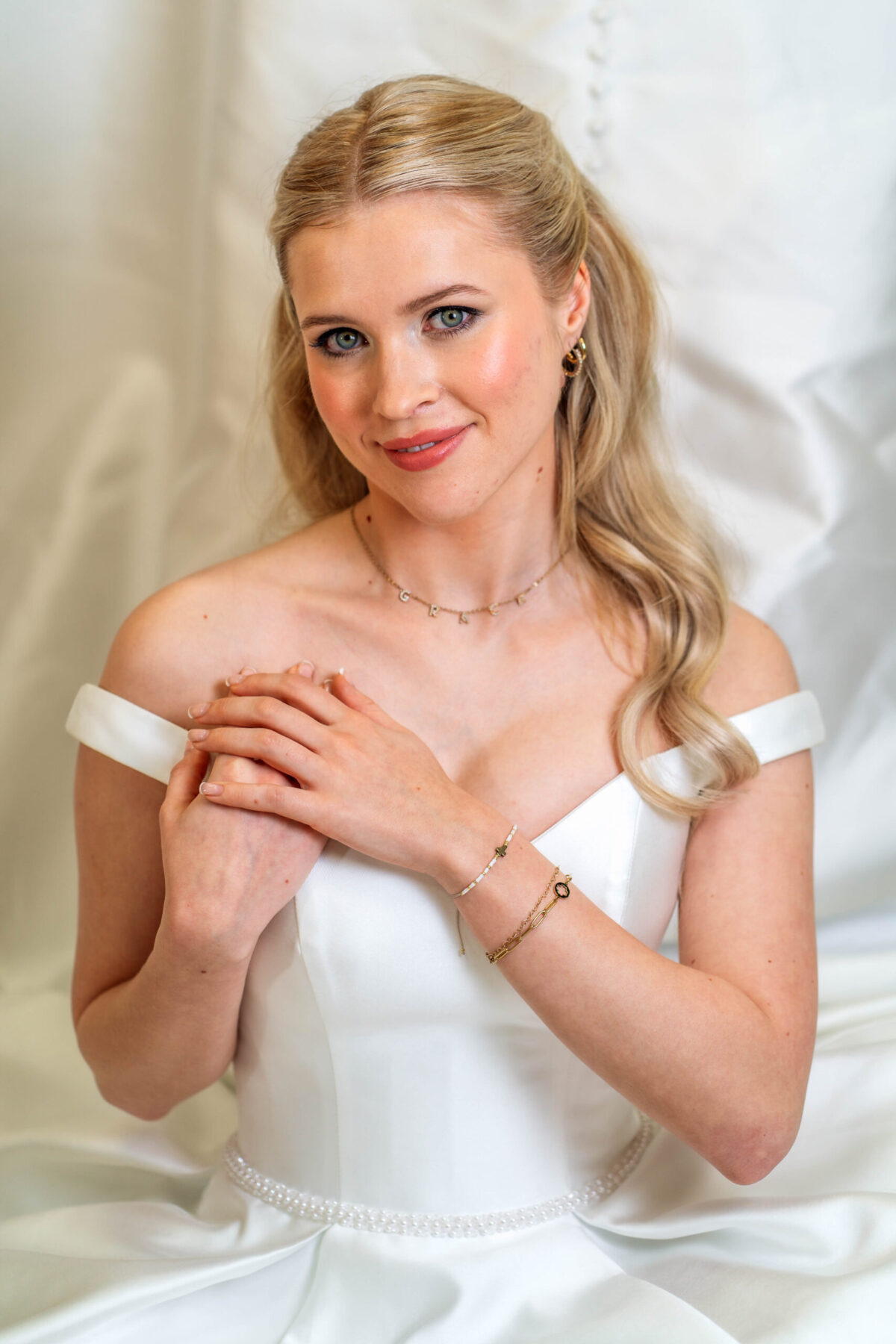 a bride sitting with her dress placed around her