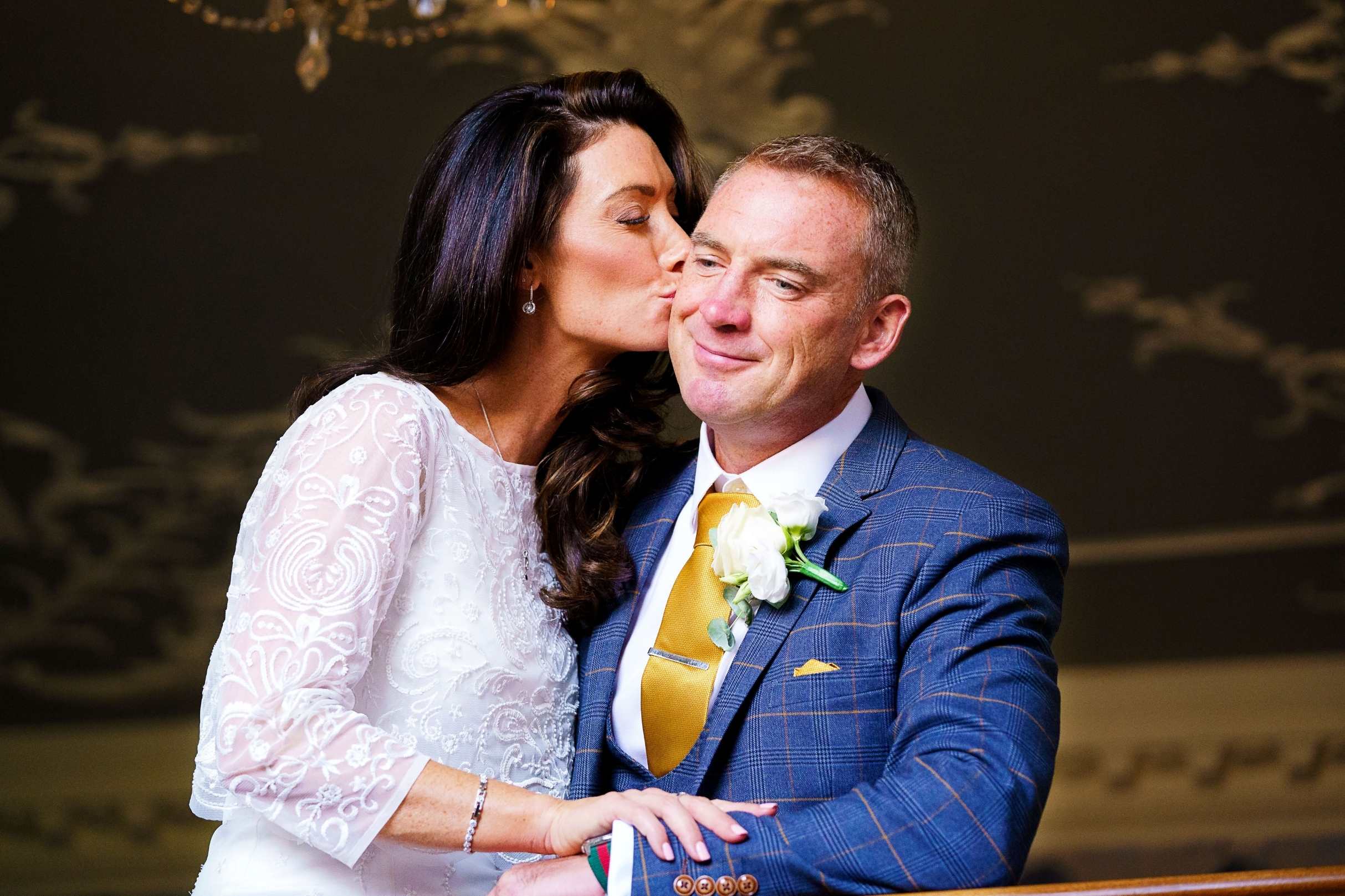 mature bride & groom.  bride kissing groom