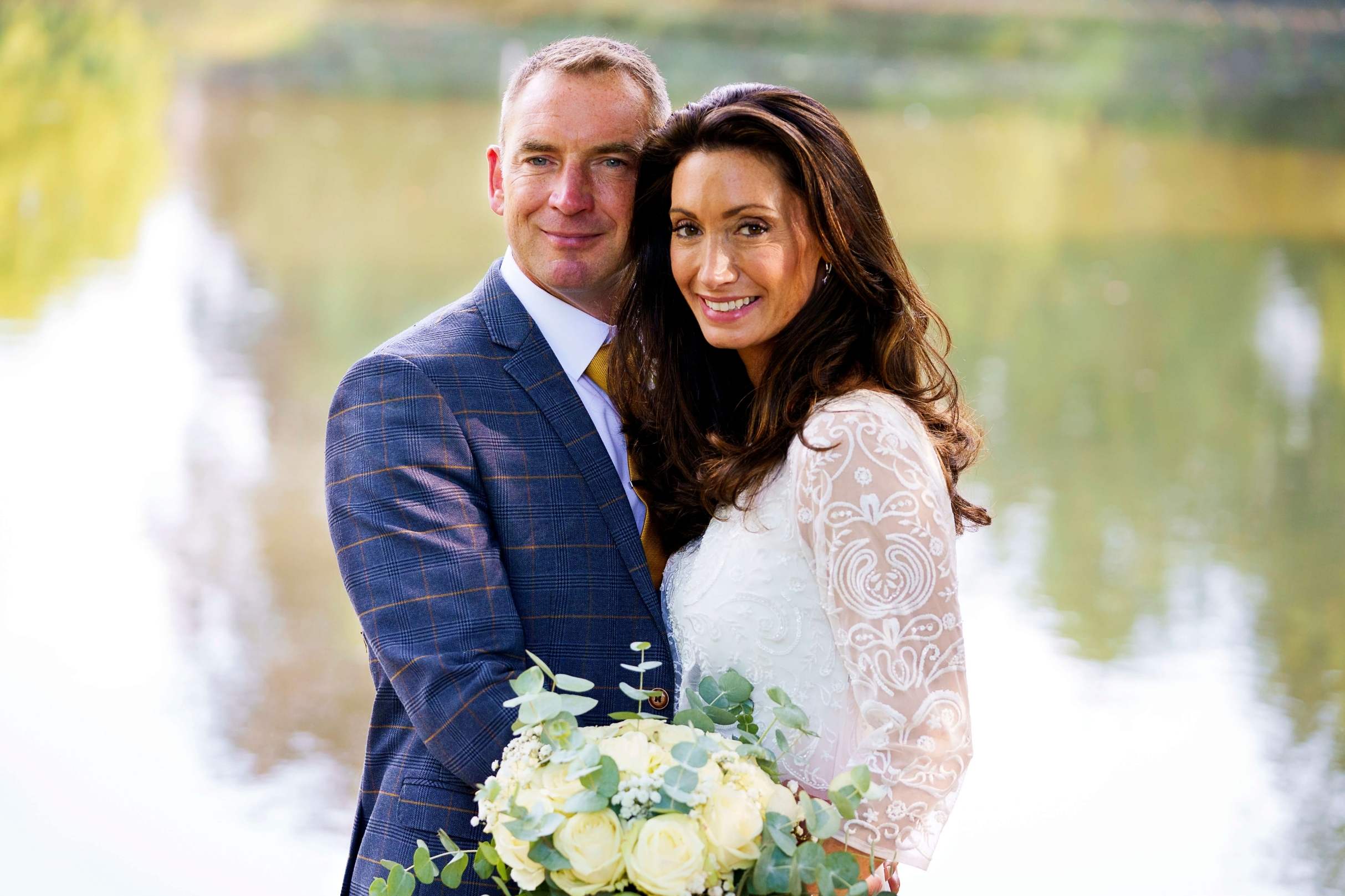 bride and groom stood by the lake at st albans manor