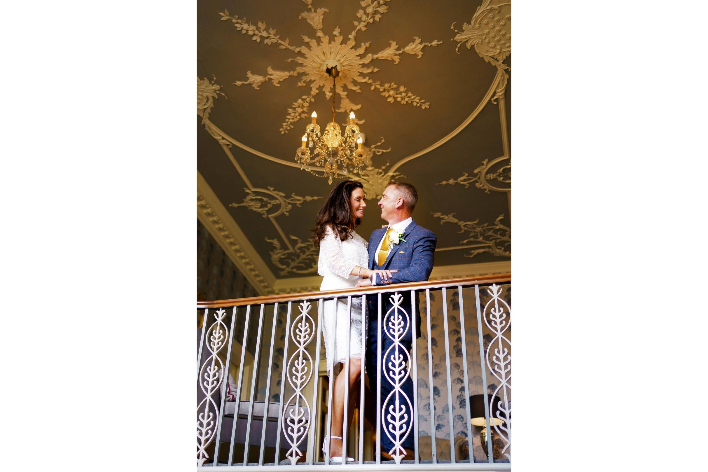 bride and groom at the top of the stairs at st michaels manor