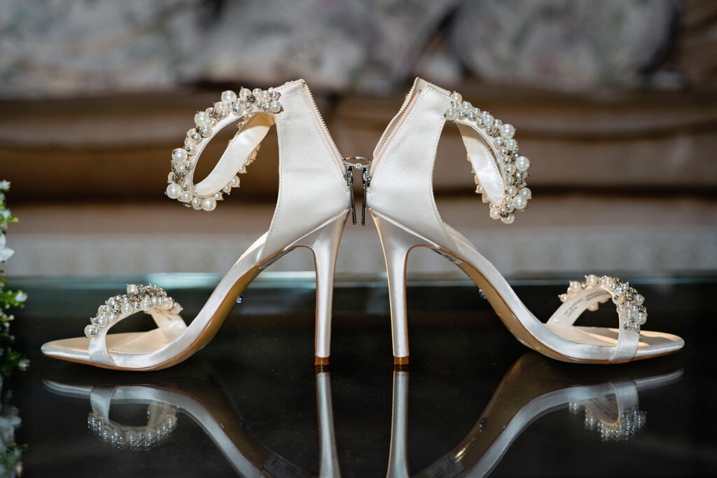 wedding at down hall- wedding shoes with engagement ring balanced between