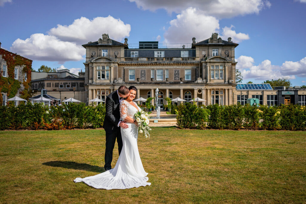 wedding at down hall - bride and groom pose in the gardens of down hall