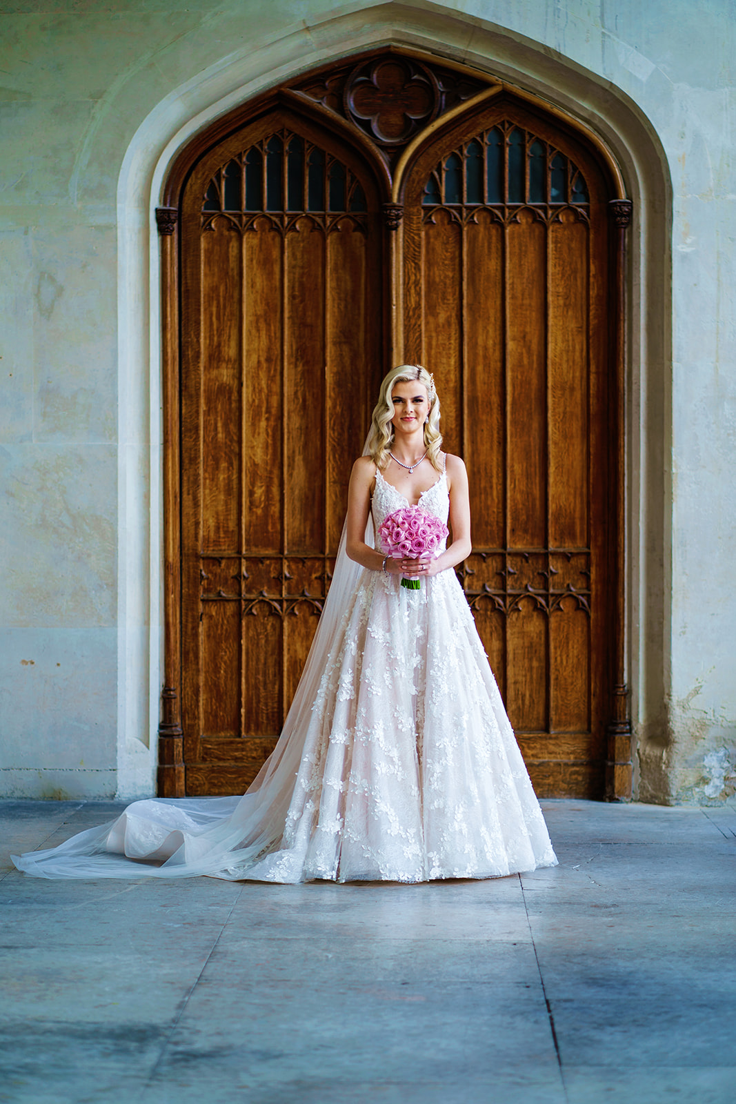 ashridge house - bride standing in front of wooden doors