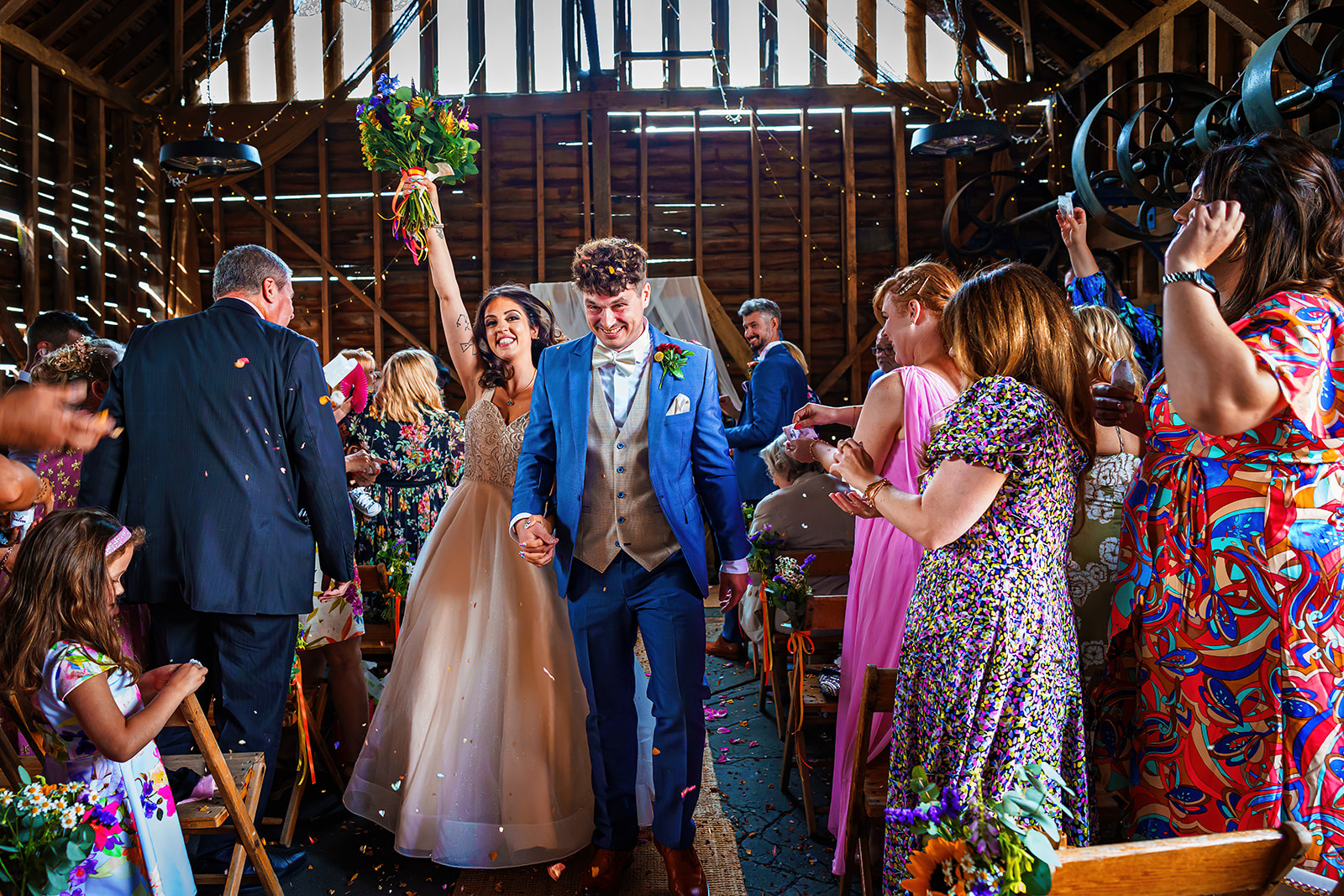 the barns at lodge farm - bride and groom walk down the aisle
