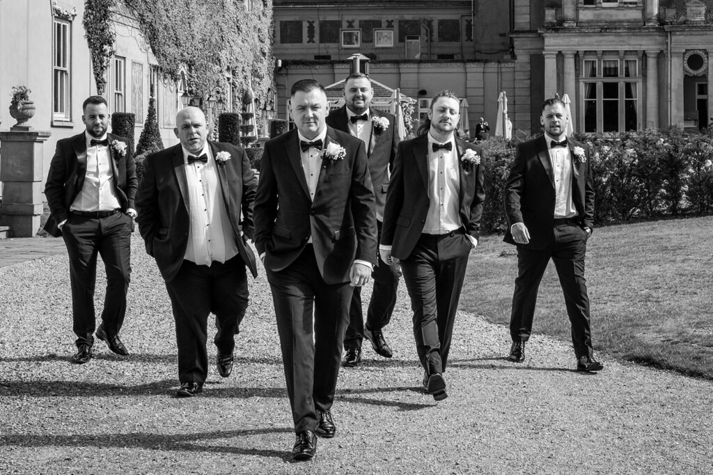 wedding at down hall - grooms party take a walk in the grounds