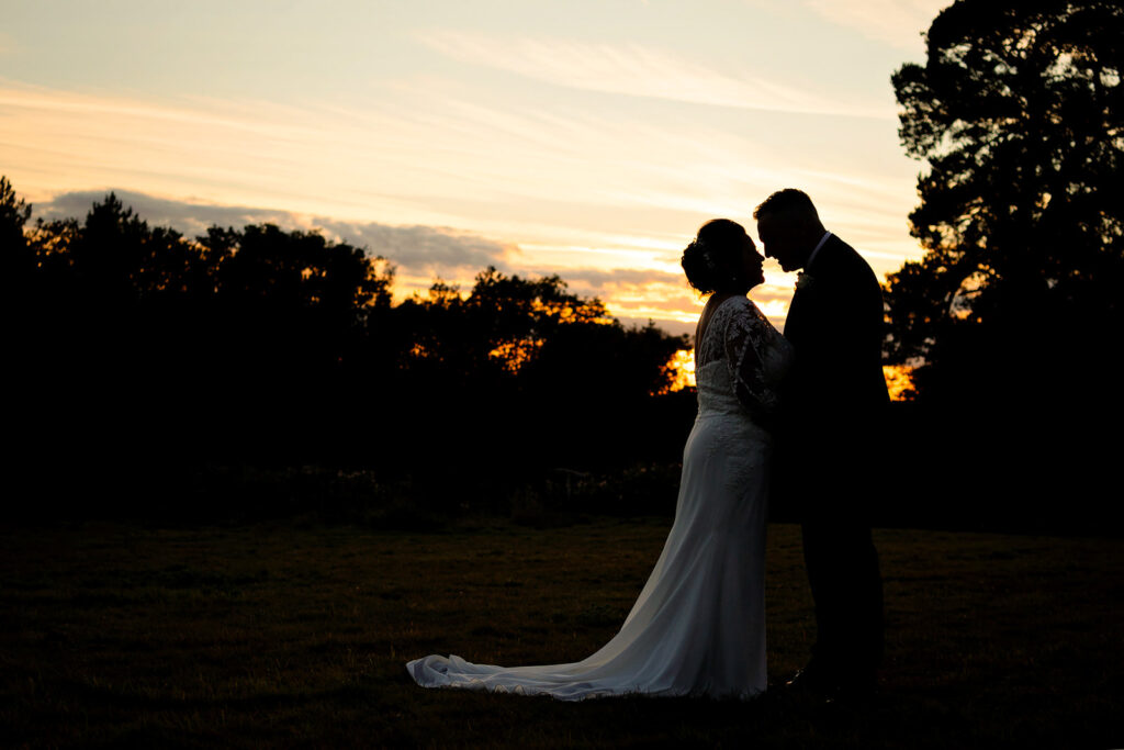 wedding at down hall - couple in silhouette at sunset