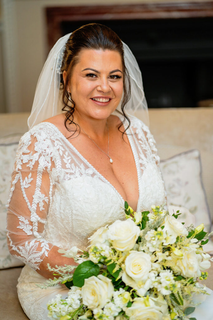 wedding at down hall - bride in her dress sitting down