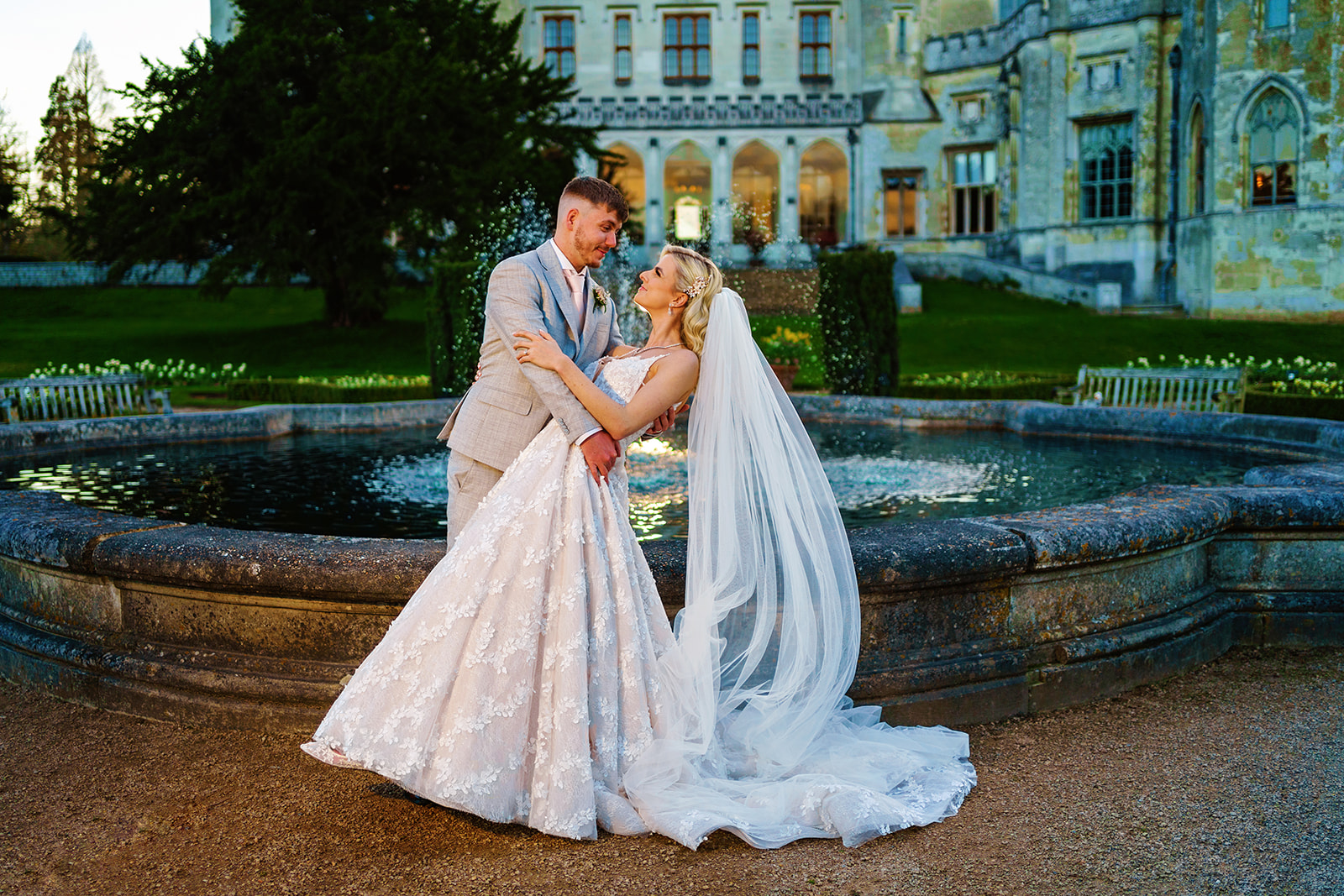 ashridge house - bride and groom in a hold in a twilight shot