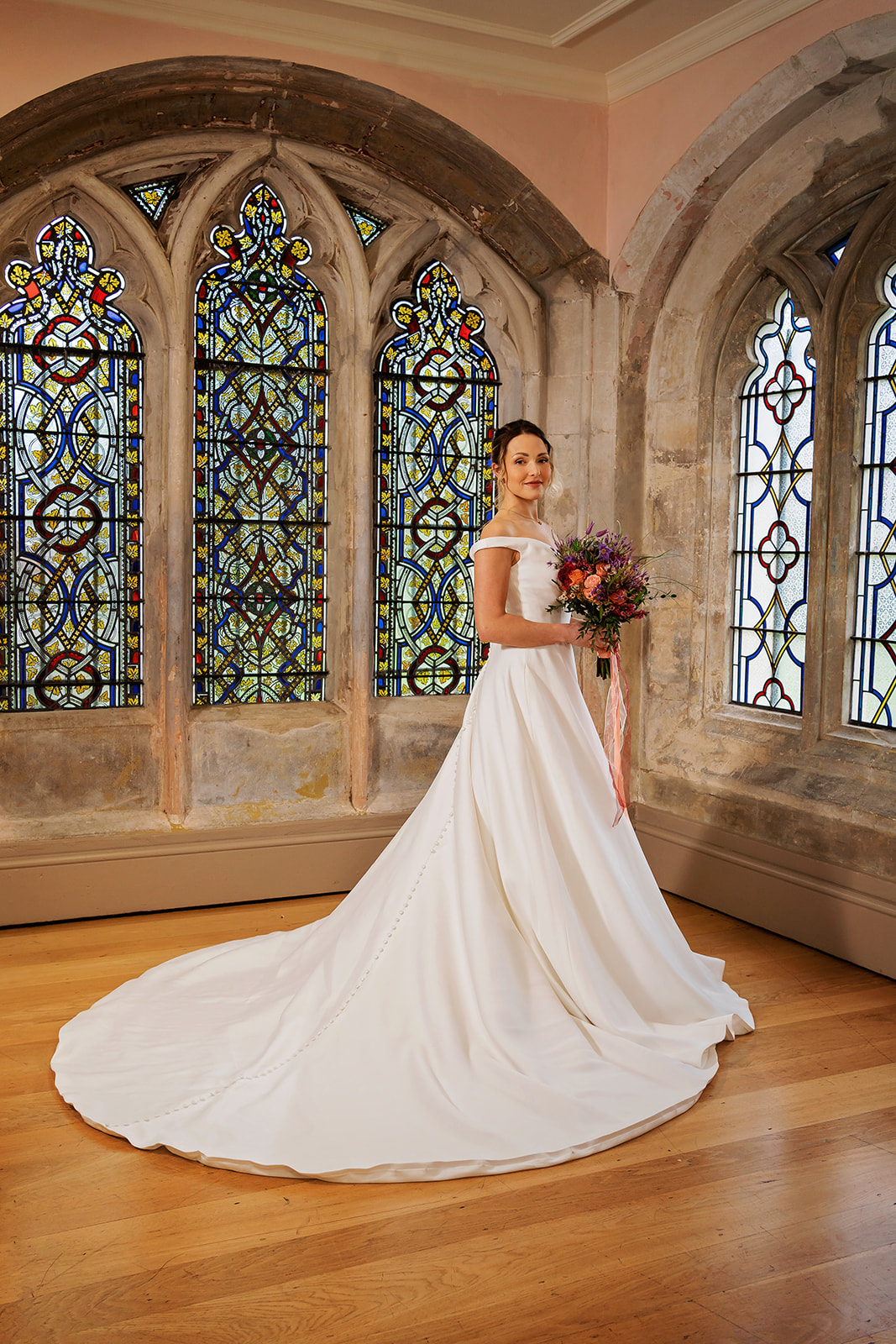 bride standing in front of stained glass