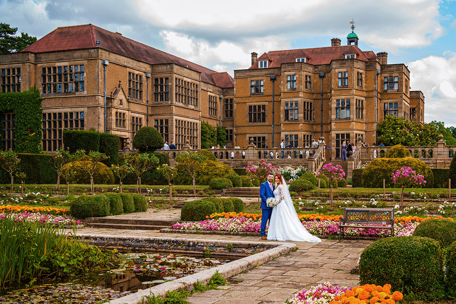fanhams hall wedding - bride and groom with fanhams hall behind them