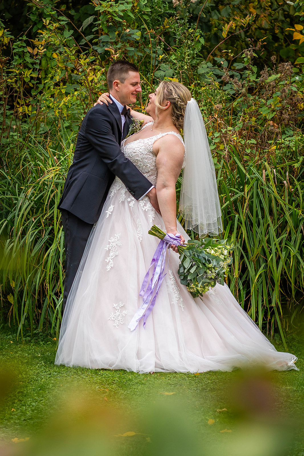 the waterside wedding venue - couple posing in front of reeds