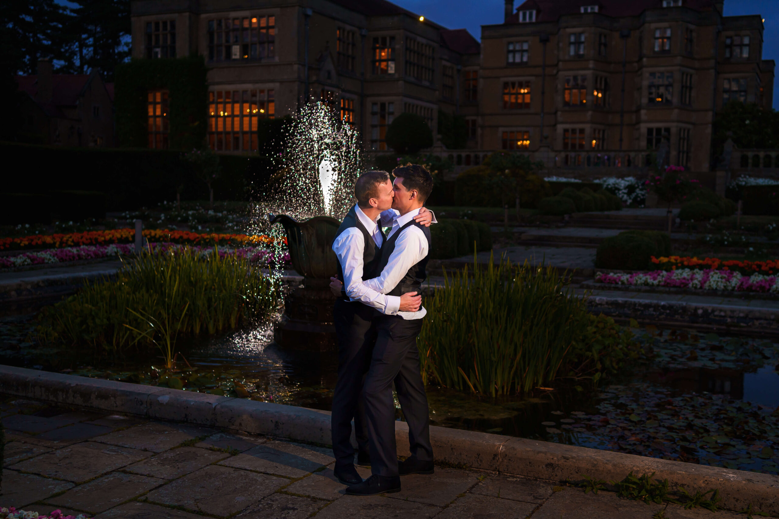 lgbtq+ - couple kissing in front of a fountain