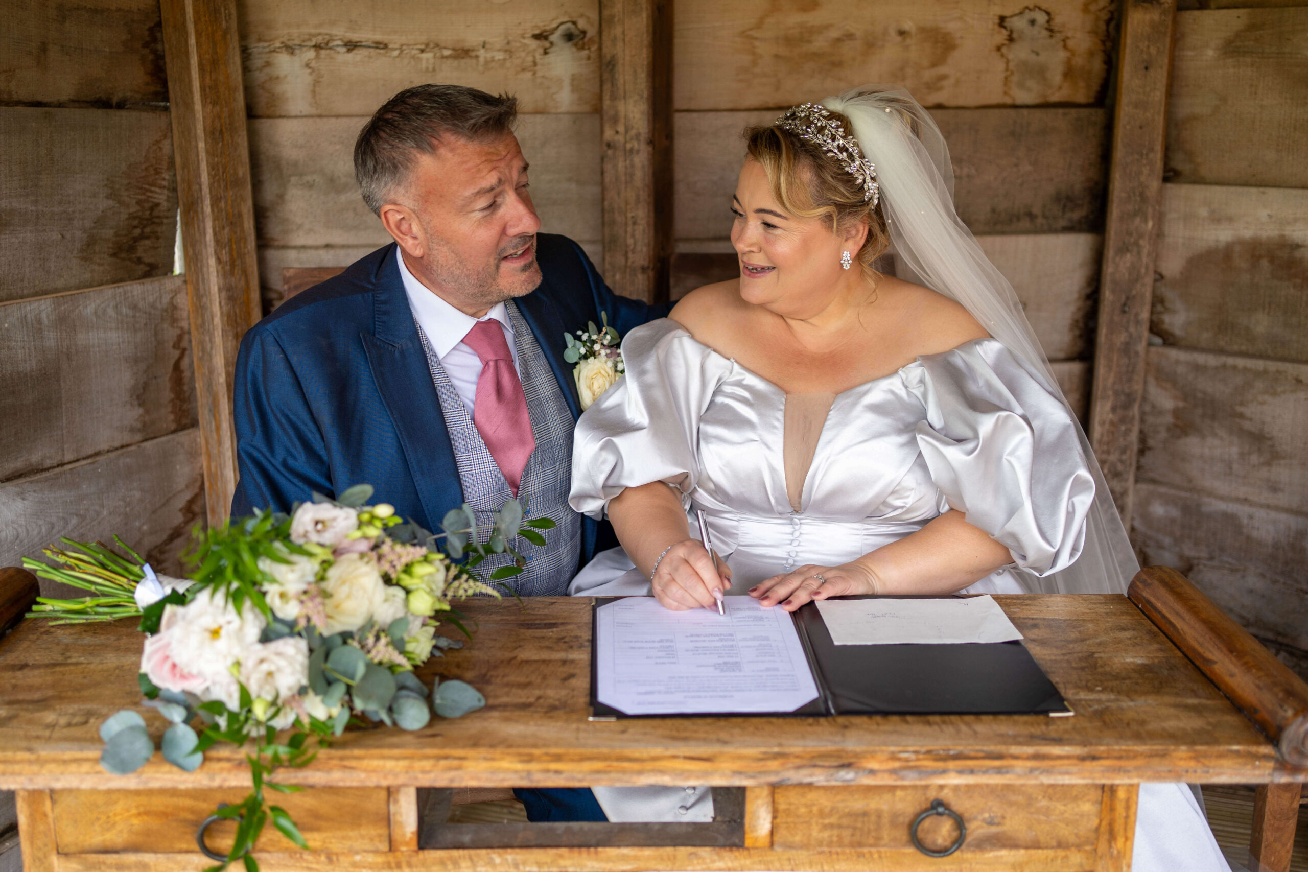 south farm wedding - bride and groom sign the register