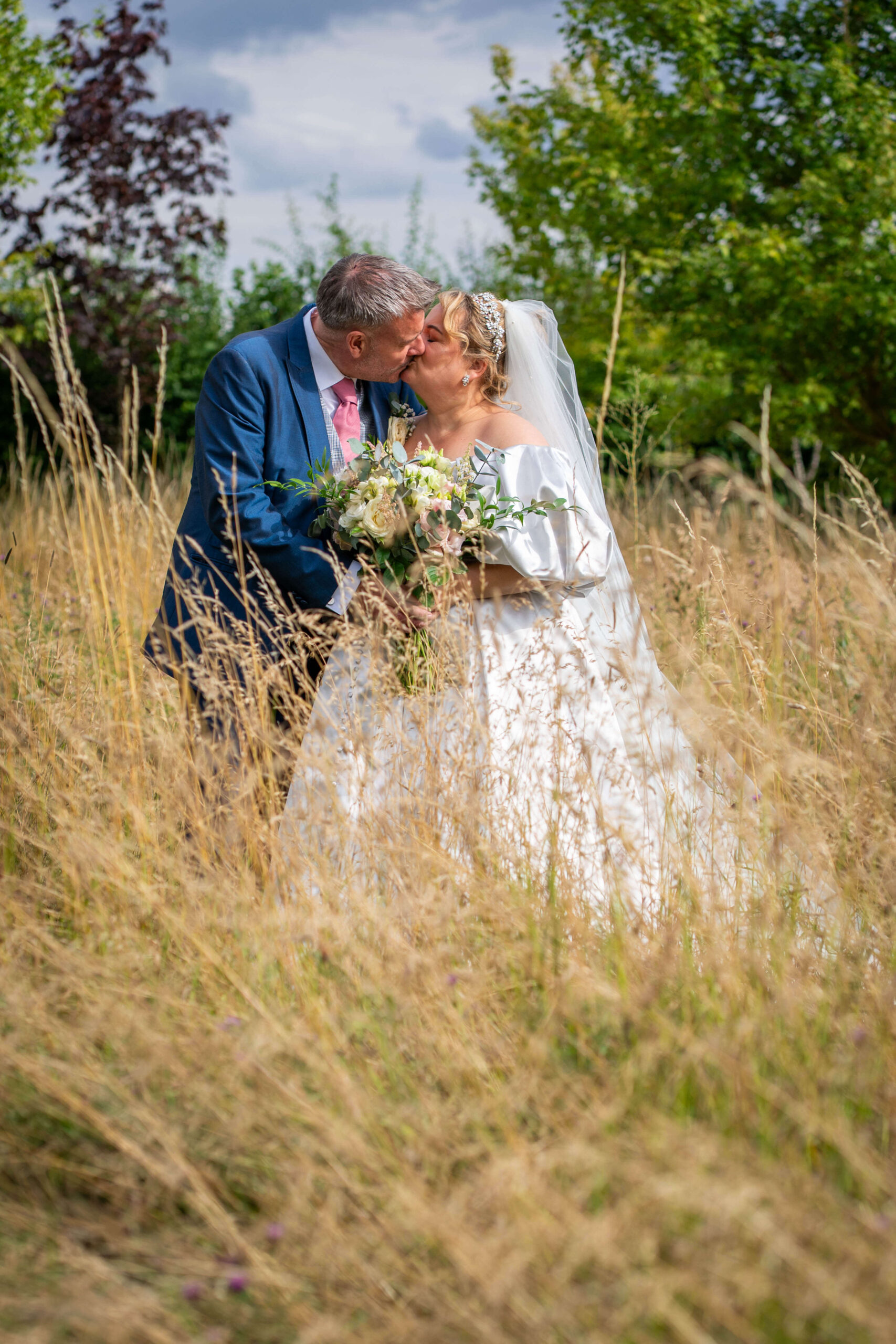 south farm wedding - couples portrait in the fields