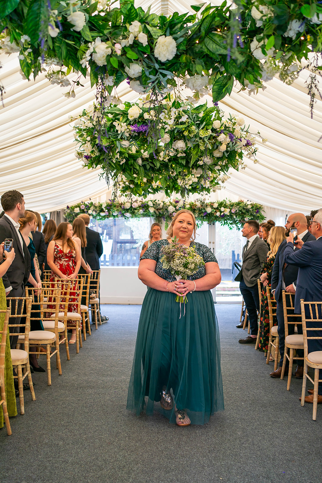 the waterside - adult bridesmaid in green walks down the aisle