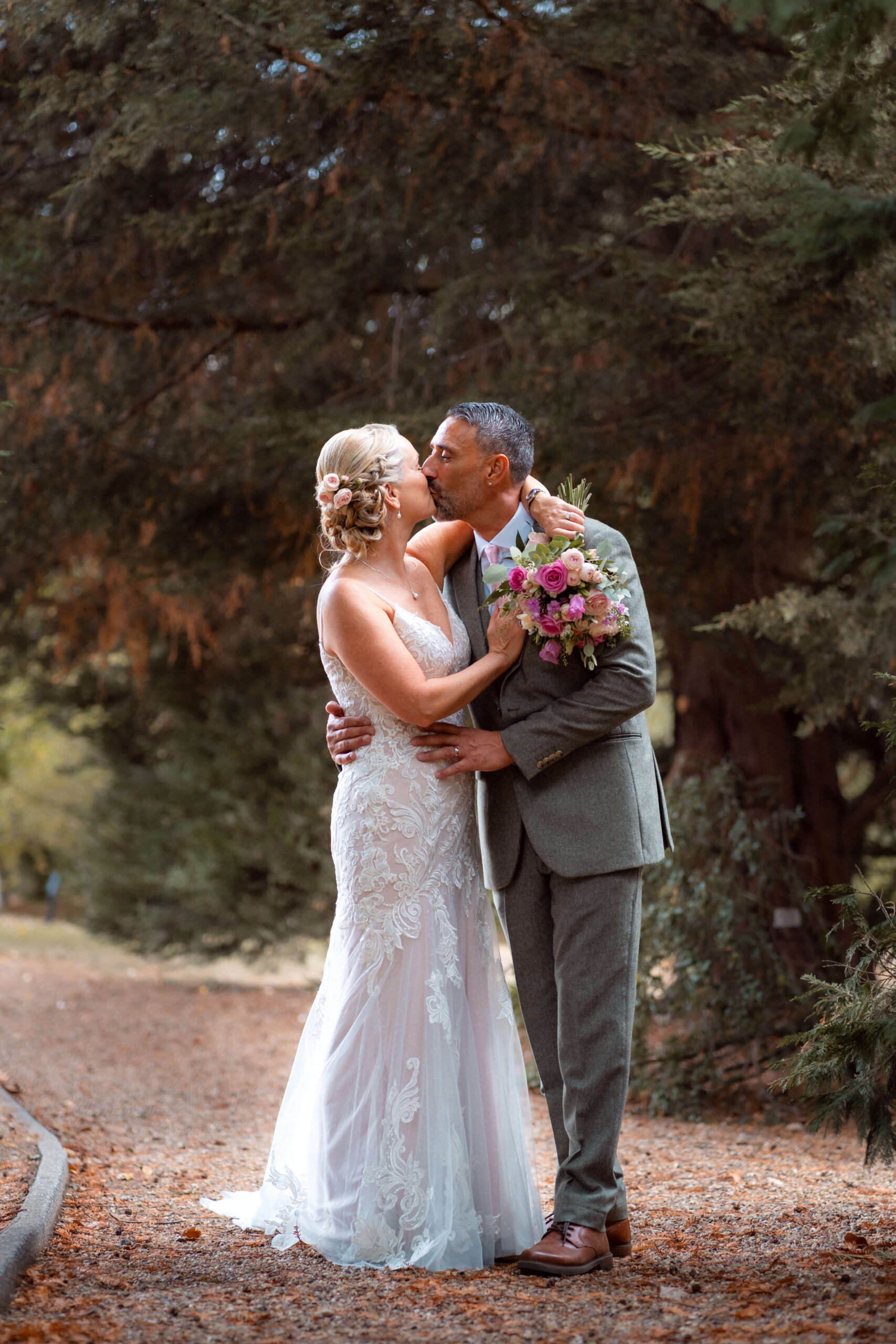 bride and groom kiss in the woodlands