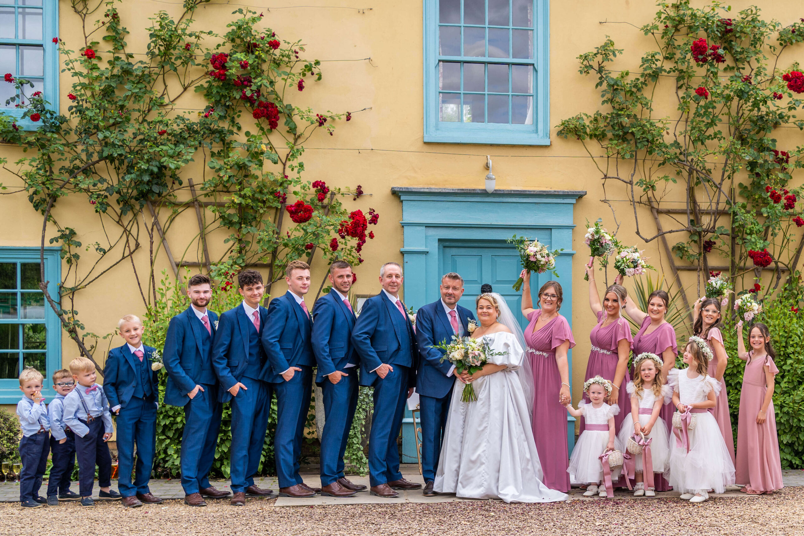 the bridal party posing in front of south farm.
